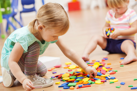 young girls playing with shape blocks
