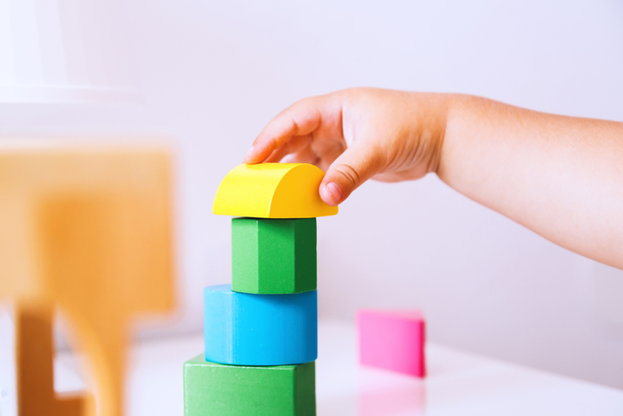 young child stacking blocks